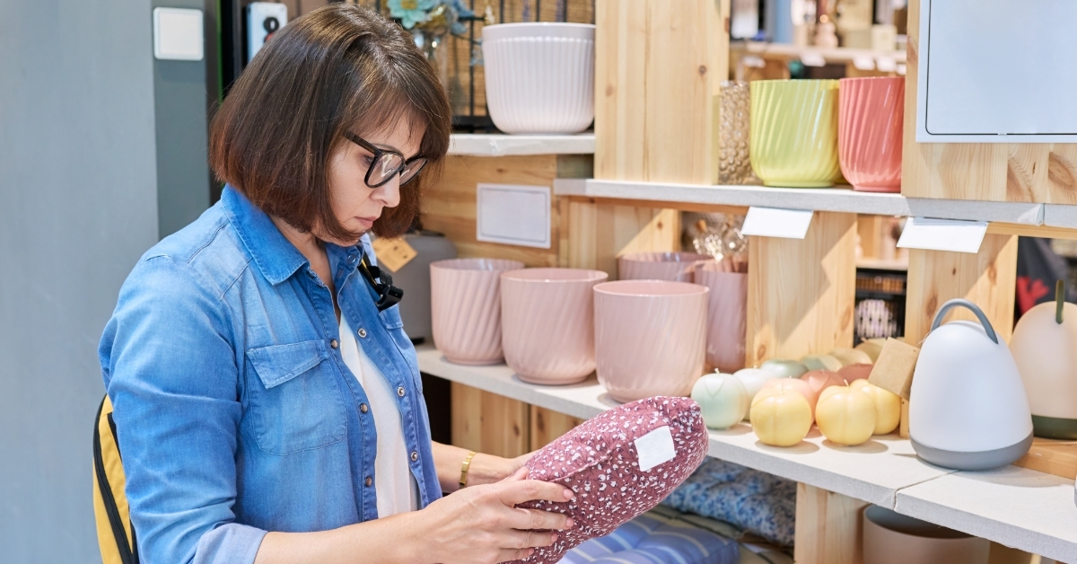 woman choosing sofa cushions in decor store