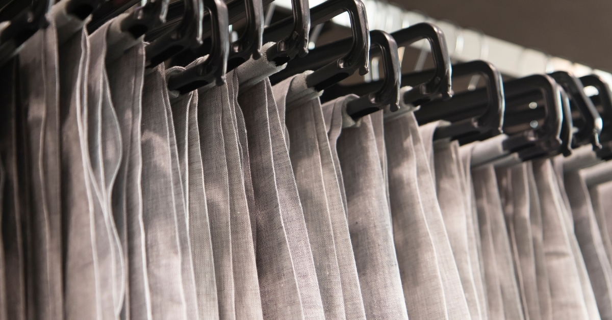 formal pants hanging on rack at store 