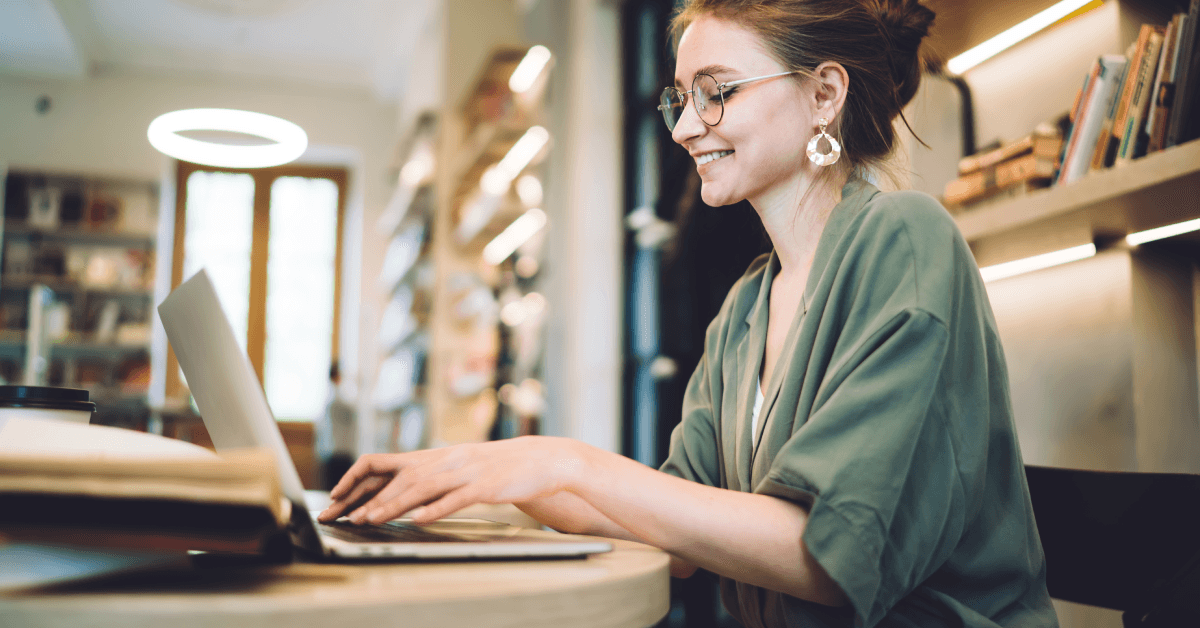 A woman types on her laptop.