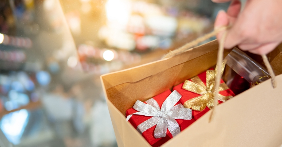 Male hand holding bag with christmas presents