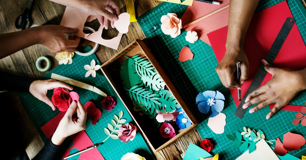 people making paper flowers at handicraft class