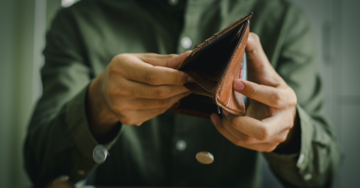 Empty wallet in the hands of a man