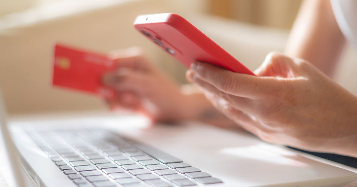 holding credit card and smartphone