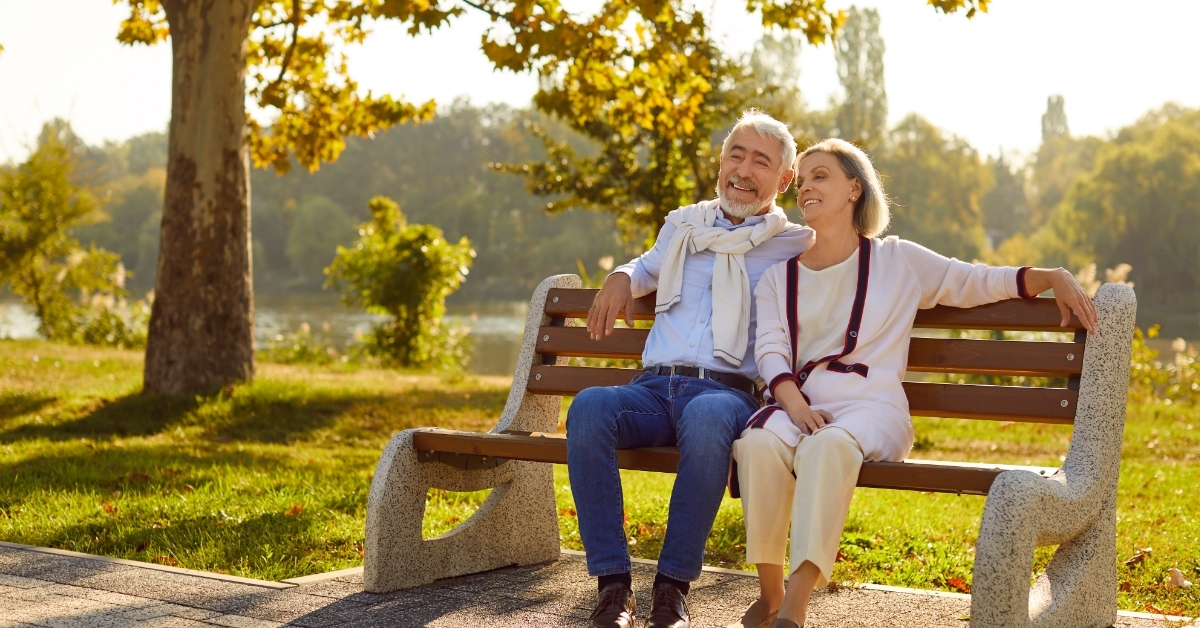 senior couple relaxing on outdoor bench