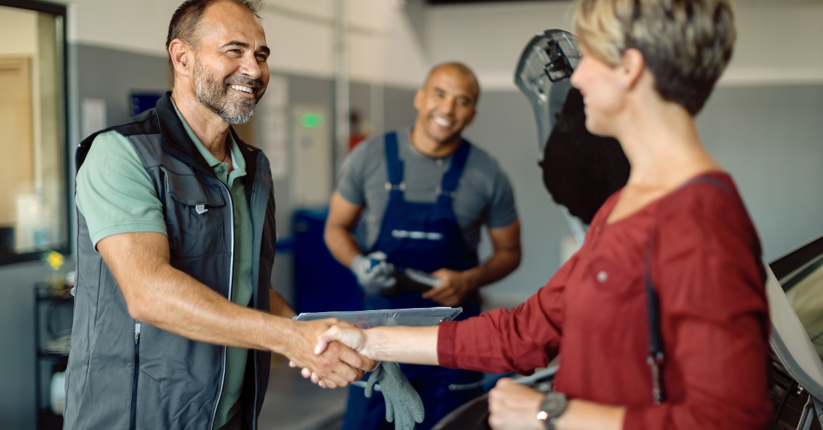 mechanic handshaking with customer