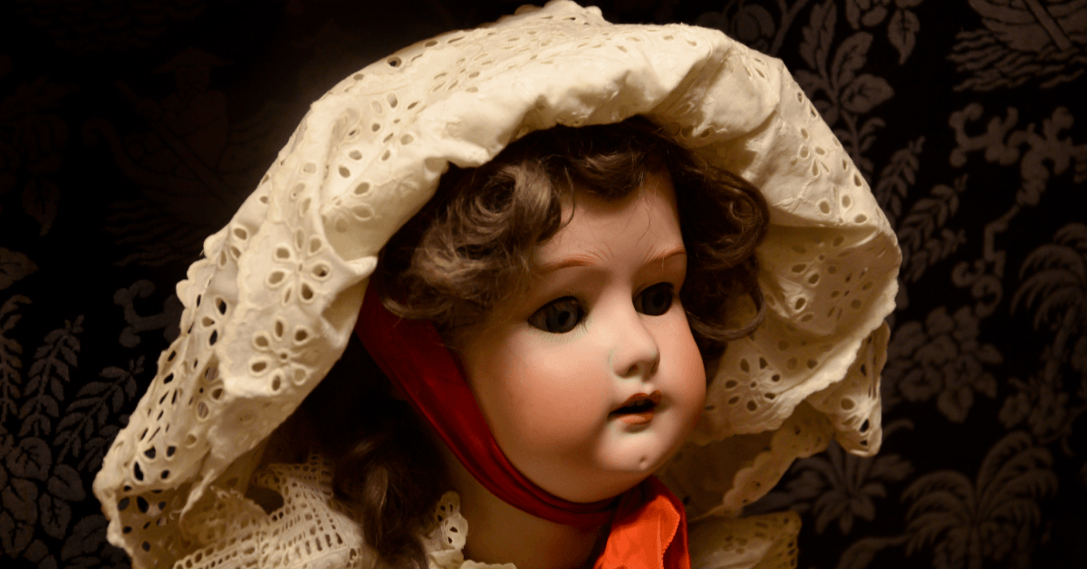 Antique porcelain doll with headdress