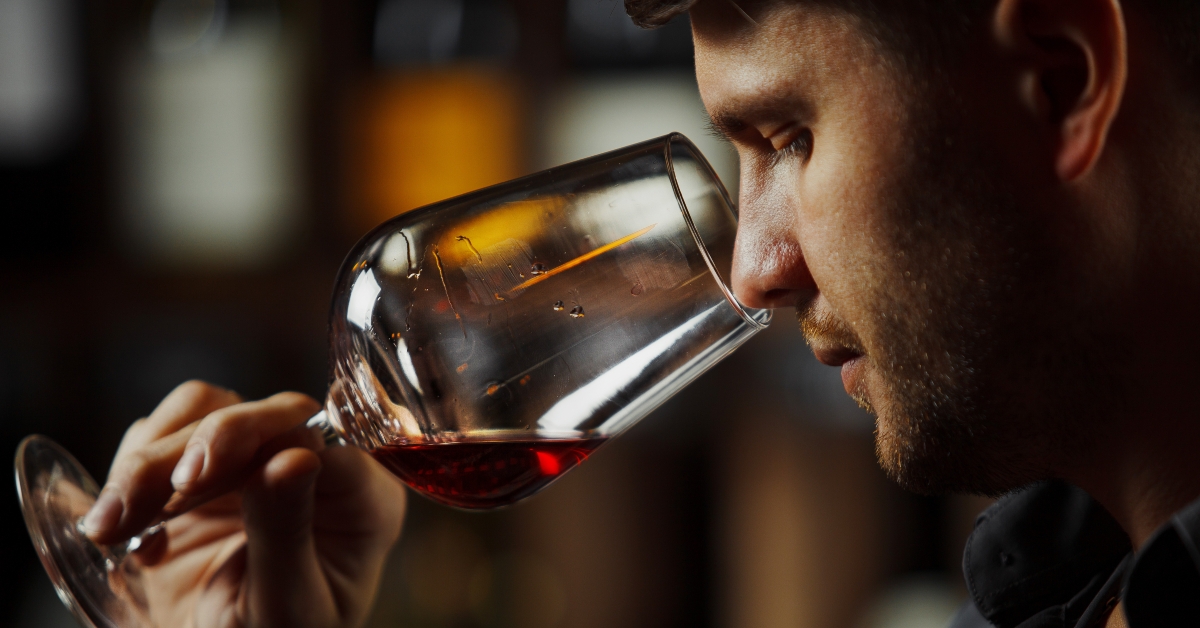 male sommelier appreciating drink