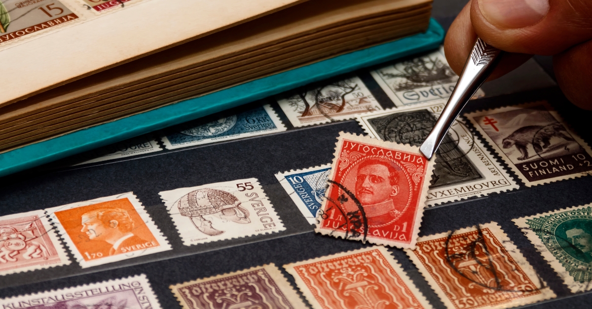 philatelist holds the postage stamp
