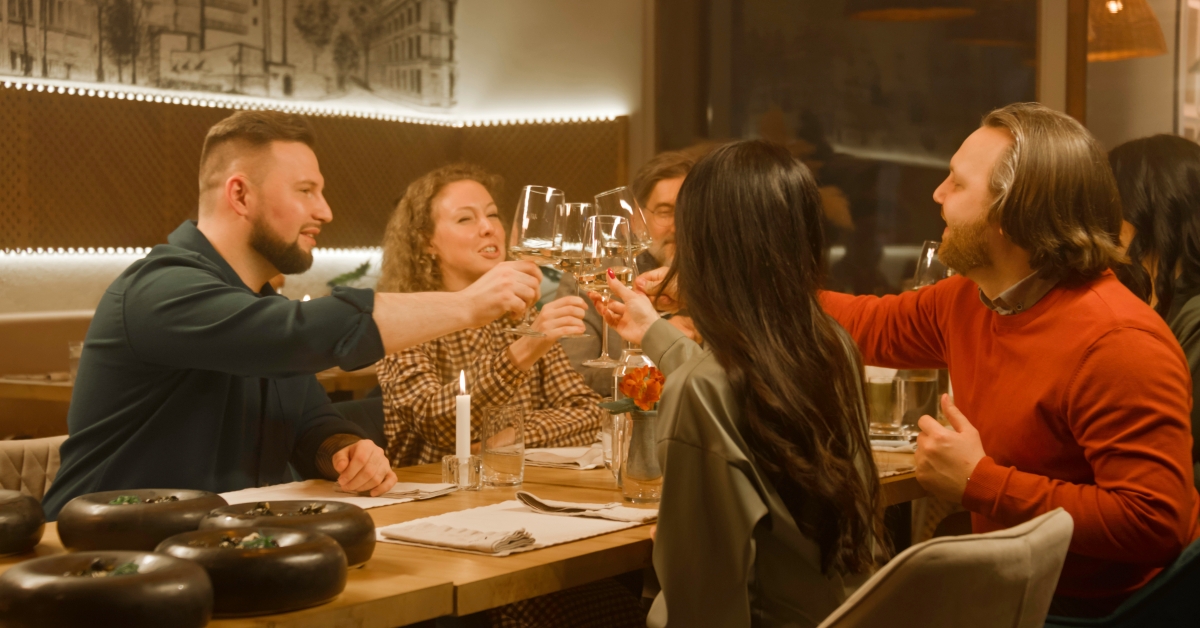 Group of people clink glasses