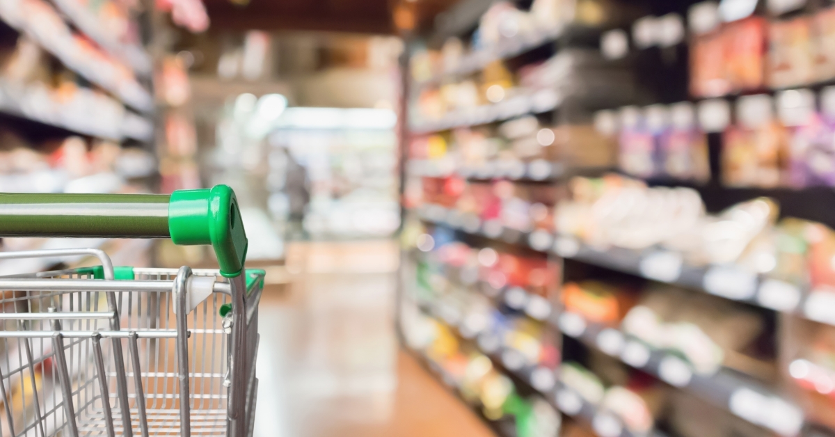 supermarket shopping cart with green handle