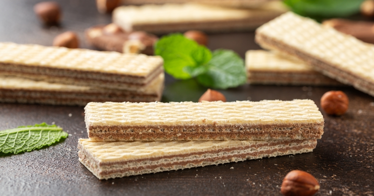 Tasty chocolate wafer on rustic table 
