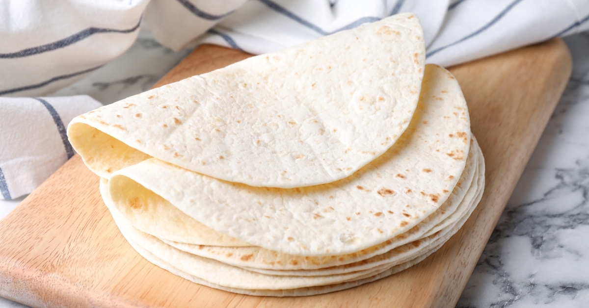 Wooden board with corn tortillas