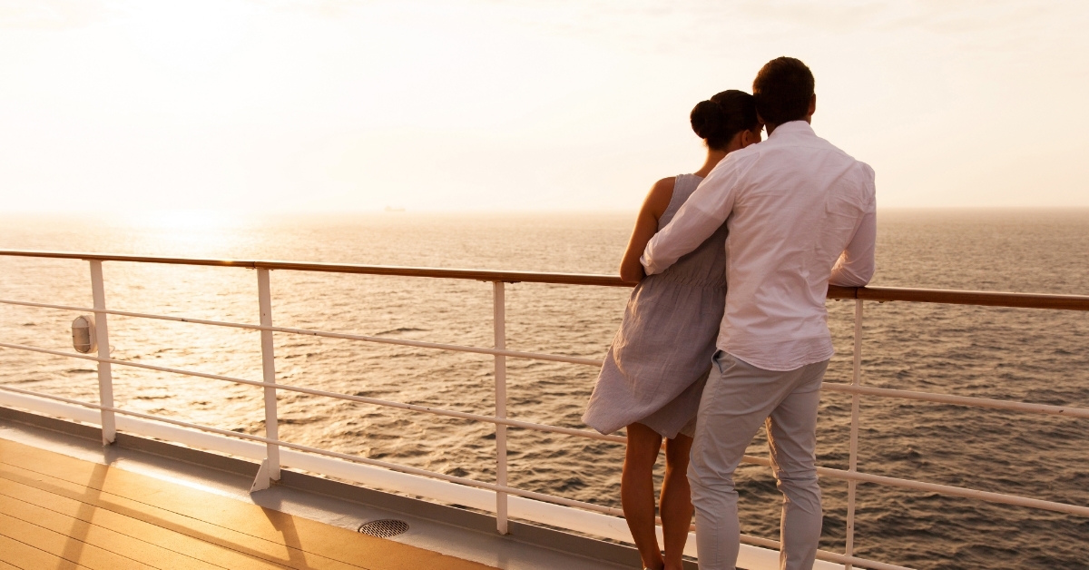 couple hugging at sunset on cruise ship