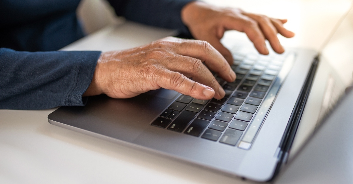 senior typing on laptop