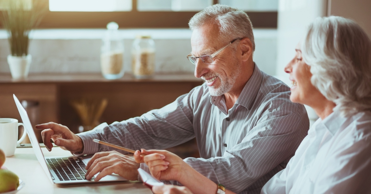 aged couple using laptop
