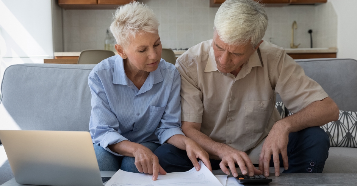 Couple paying paper bills