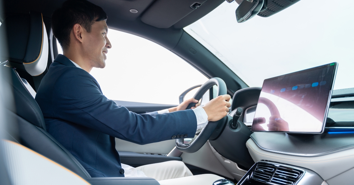 Asian businessman driving car