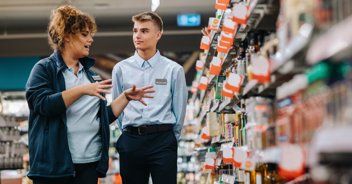 Supermarket manager giving training to trainee