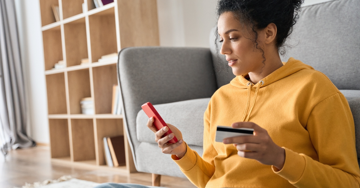 female consumer holding credit card
