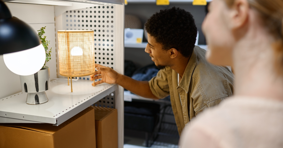 couple looking for bedside lamp in shop