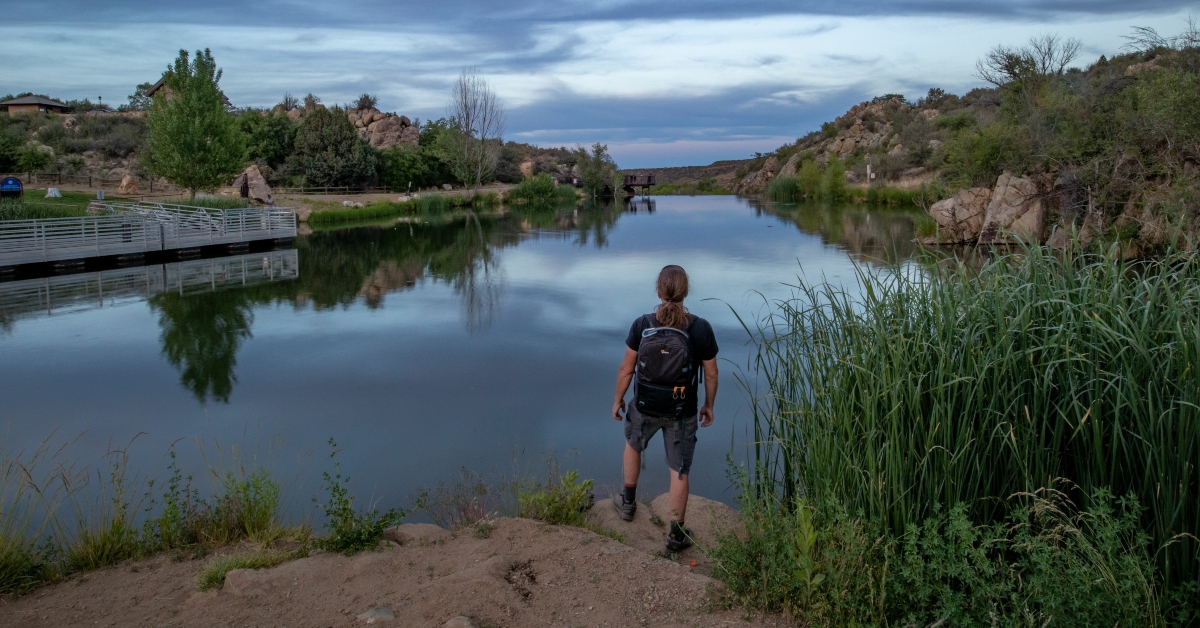 male hiker admiring the view of Fain Lake