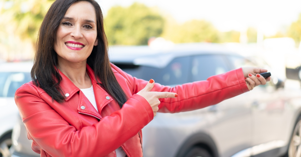 woman holding car keys with happy expression