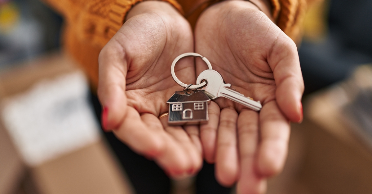woman holding key of new house