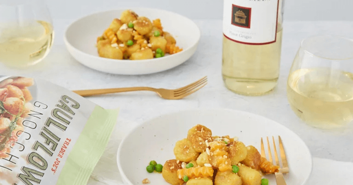 Two plates and white wine Cauliflower Gnocchi from trader Joe's