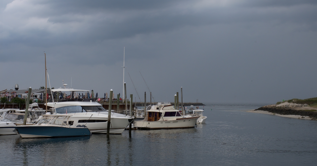 Threatening dark gray storm clouds over boats