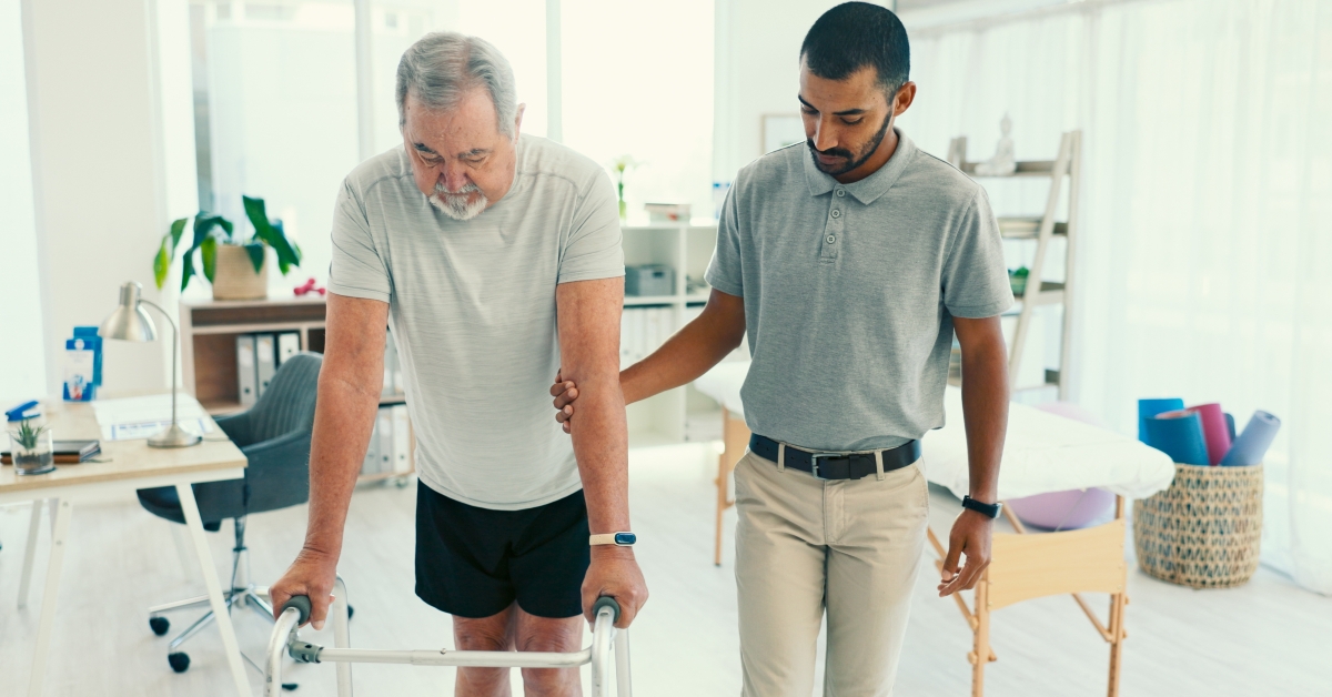 Physiotherapist, walking frame and help for patient