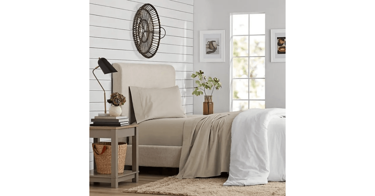 Bedroom with beige sheets and white comforter
