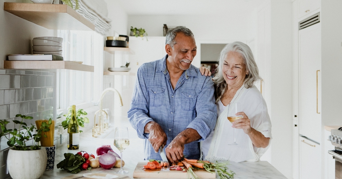 elderly couple cooking in a kitchen