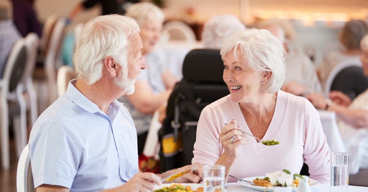 senior couple eating meal and talking
