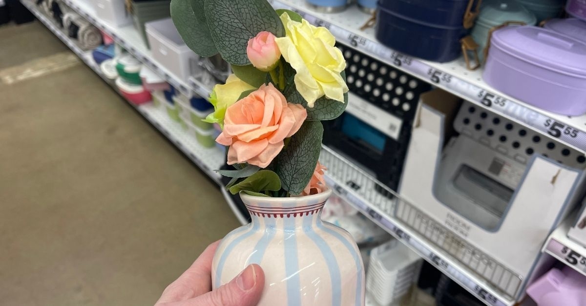 person holding a flower vase
