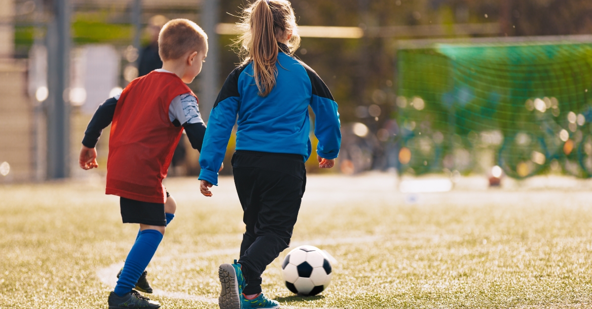 children kicking soccer ball