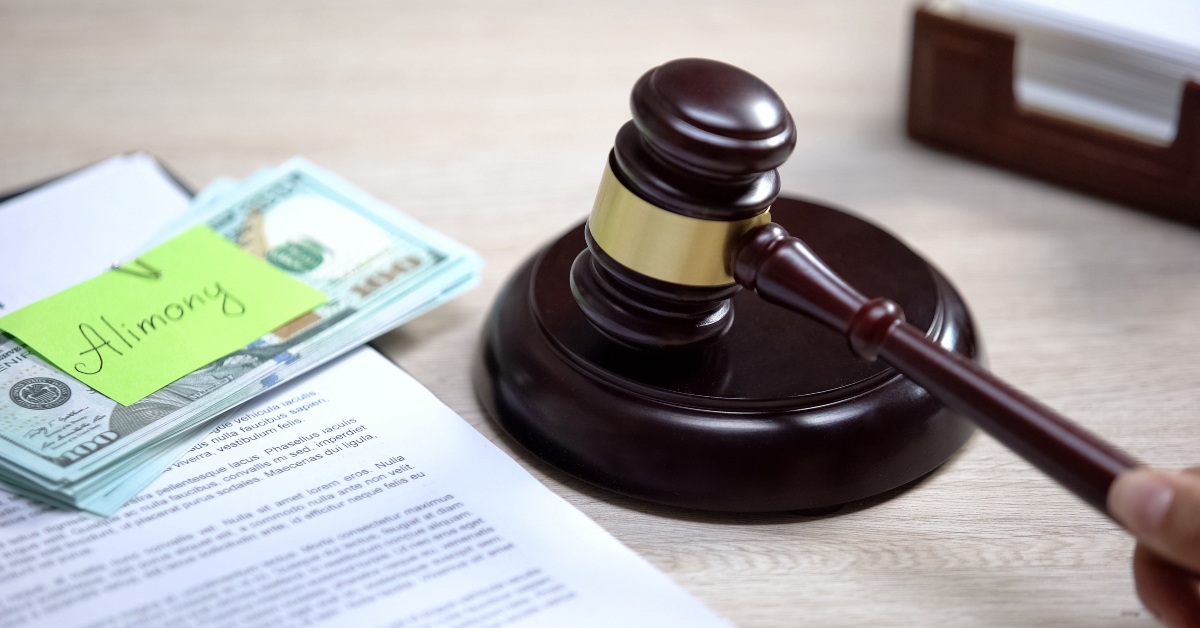 Dollars with alimony sign table, gavel standing sound block