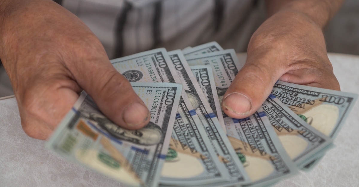 man holding american dollar bills