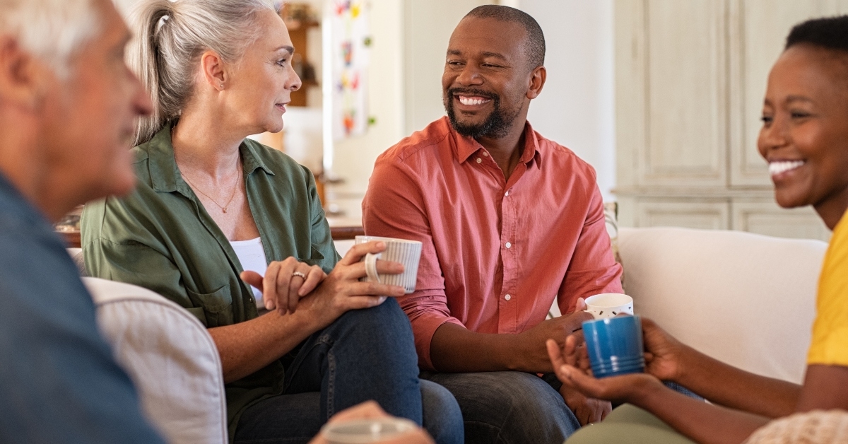 mature friends in conversation at home
