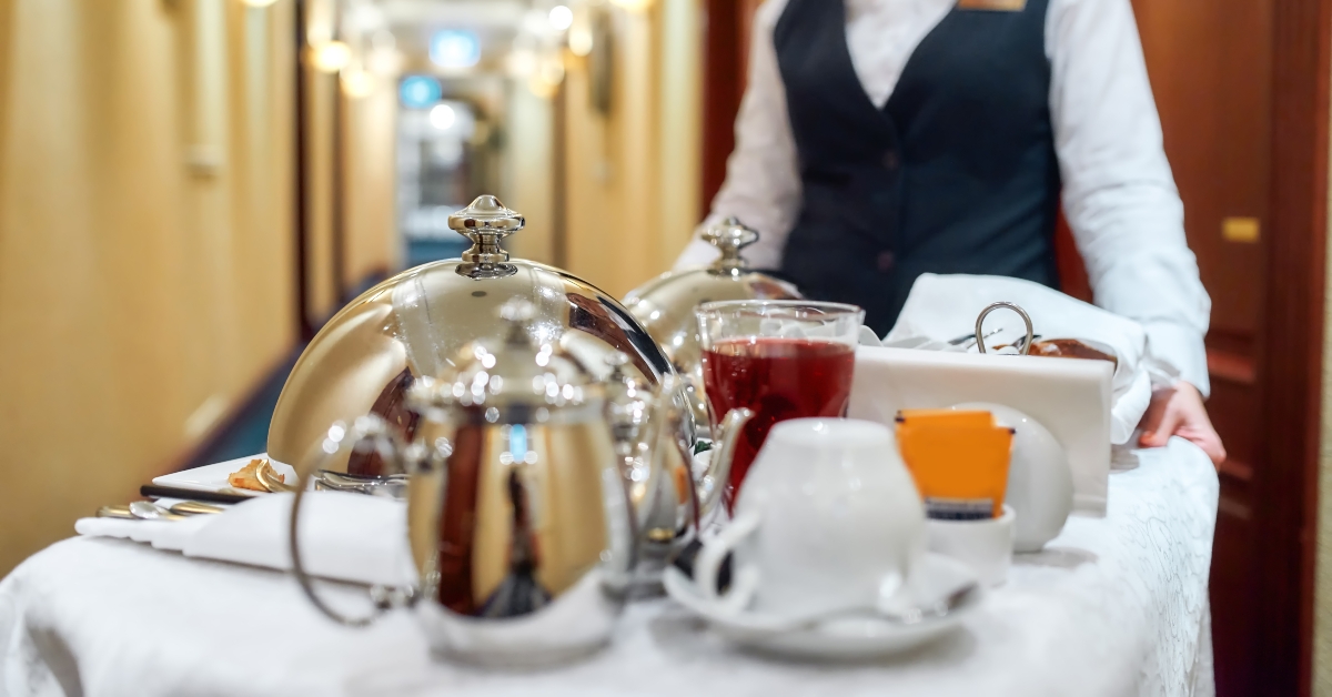 Waitress in uniform delivering tray