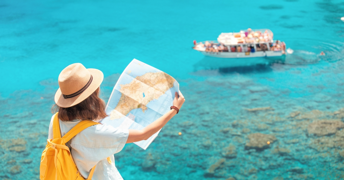Cheerful girl with a map exploring interesting places