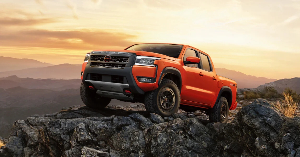 A red nissan frontier above the rocks