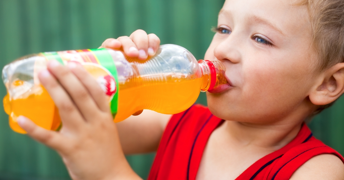  Boy drinking unhealthy bottled soda