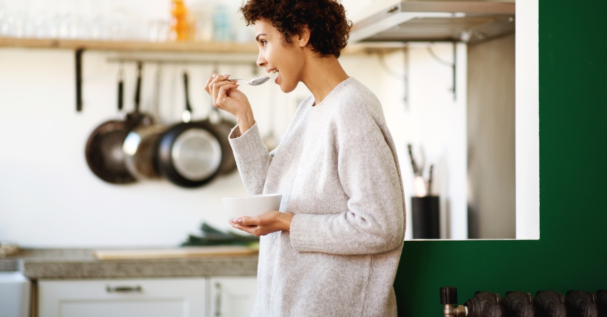 woman eating cereal at home