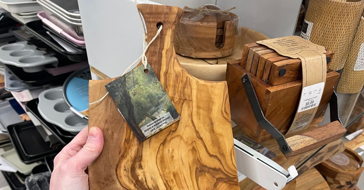 person holding a wooden cutting board