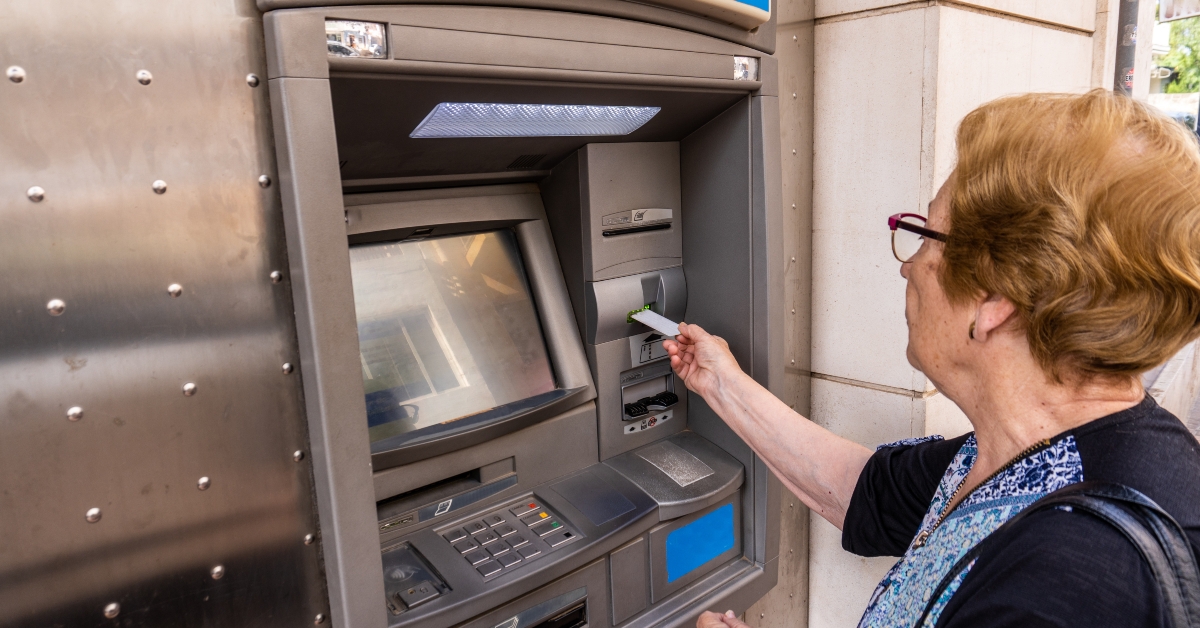 elderly woman using atm