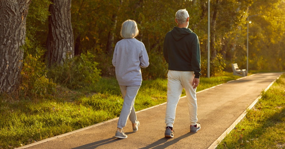 Senior active couple, old spouses enjoy walking outdoor