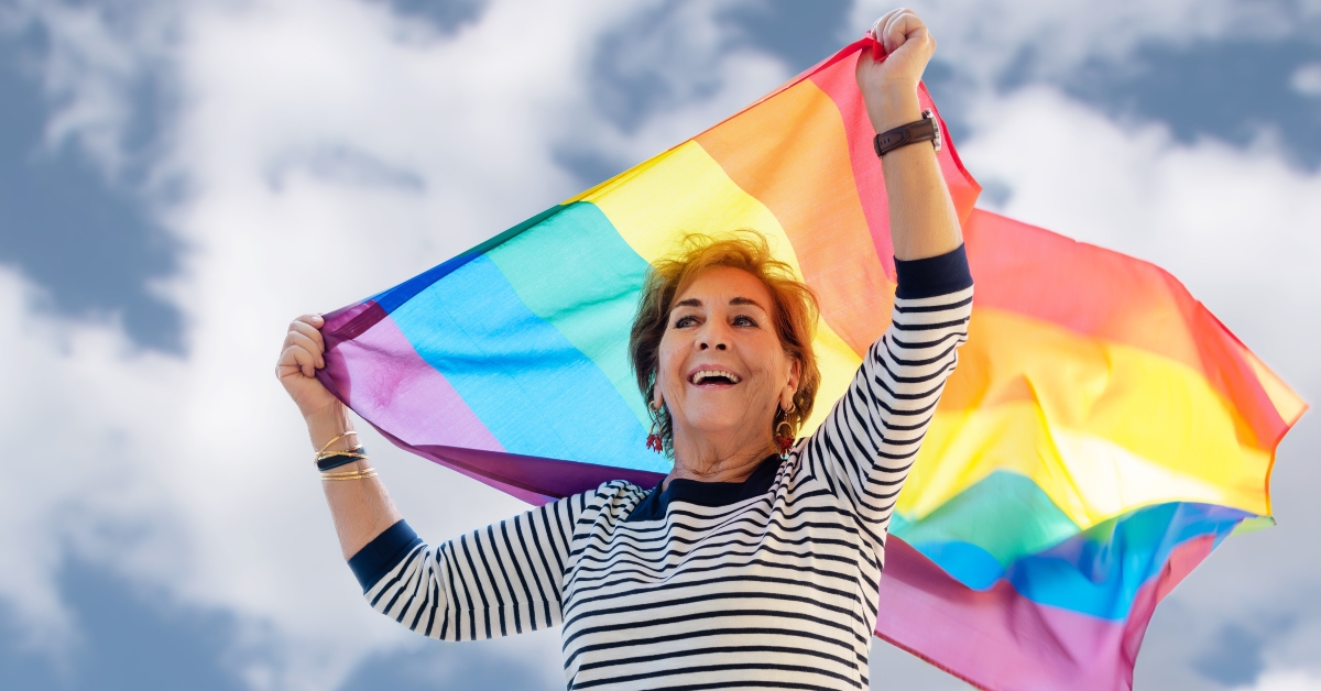 older lady waving the rainbow colored flag