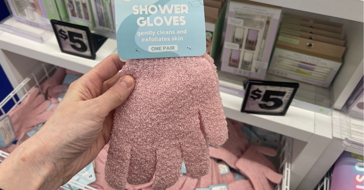 person holding a pink shower gloves