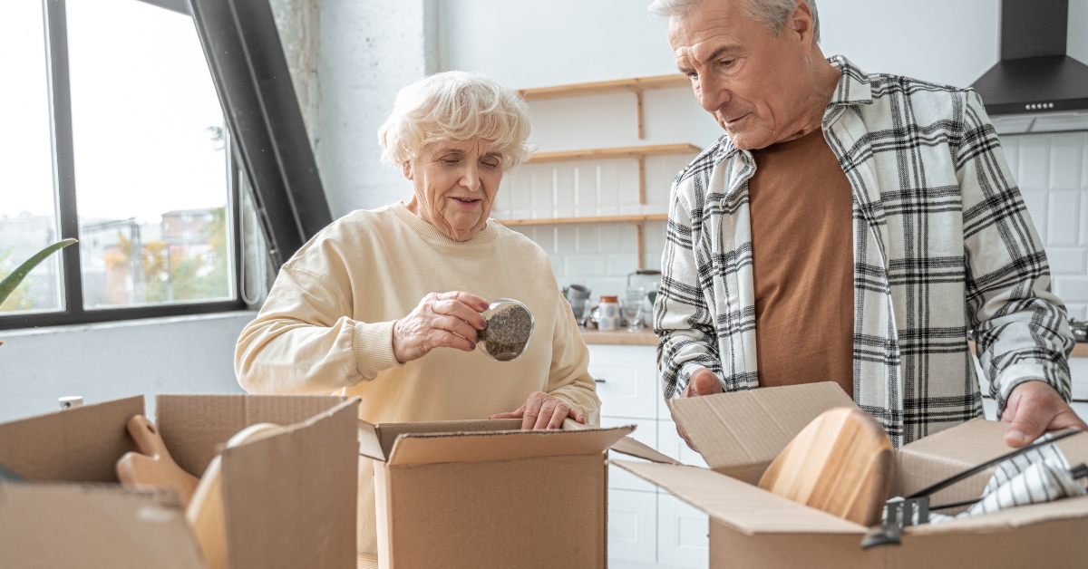 senior couple moving into a new home and unpacking boxes