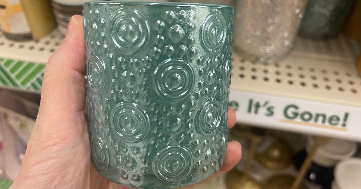 person holding a candle holder